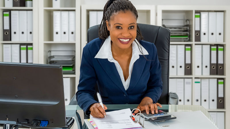 Young, black woman, accounting professional working in the office.
