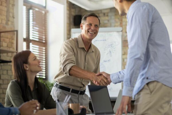 approach a smiling person in the conference room