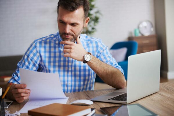 business person reading important documents at his desk