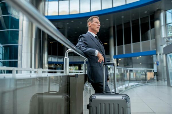 quiet-pensive-airport-terminal-with-suitcase-standing